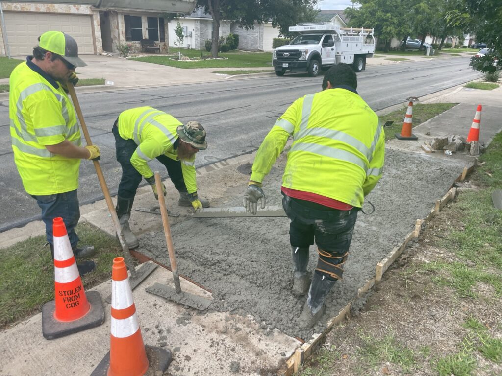 A crew pours concreate for a sidewalk improvement project in Pinnacle neighborhood.